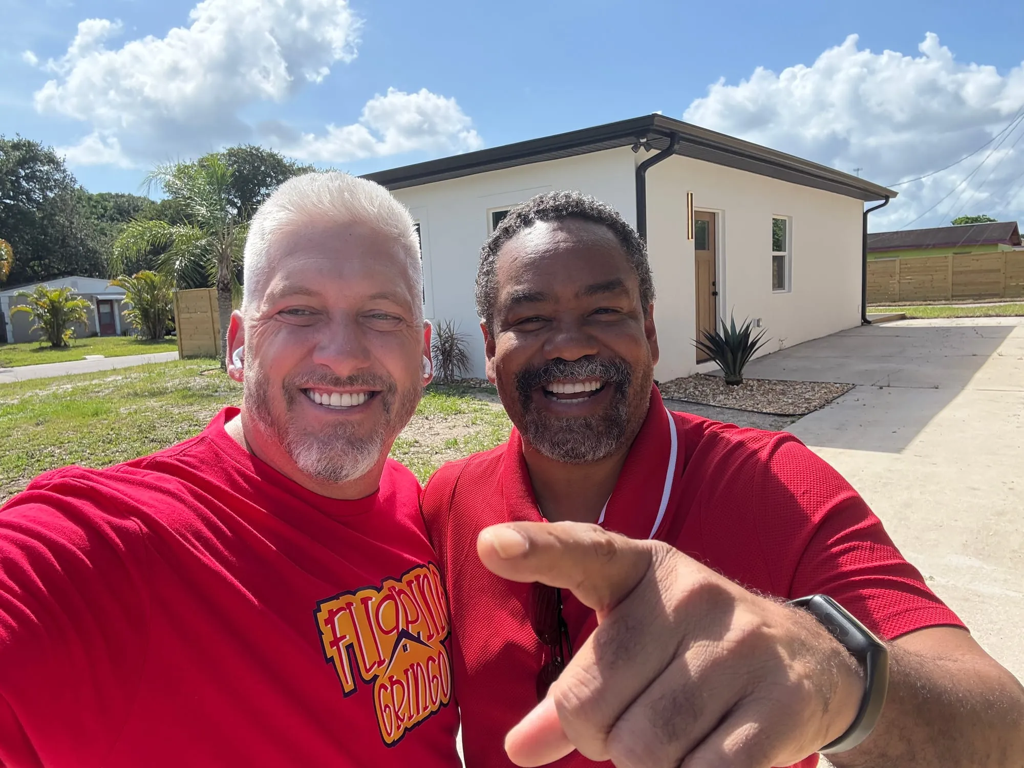 The Flipping Gringo team in front of a finished renovation
